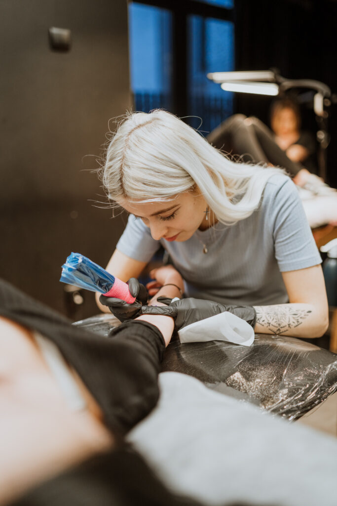 tattoo artist performs tattoo in cracow tattoo studio